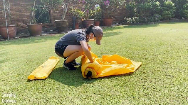 This is a picture of me rolling up the tent body of the Teton Sports 2-Person Vista Quick Tent along with the rainfly to get it back into the carry bag.