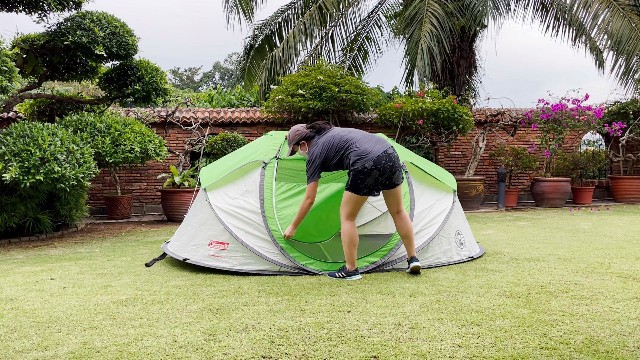 This is a picture of me zipping up the window and door of the Coleman 4-Person Pop Up Tent.