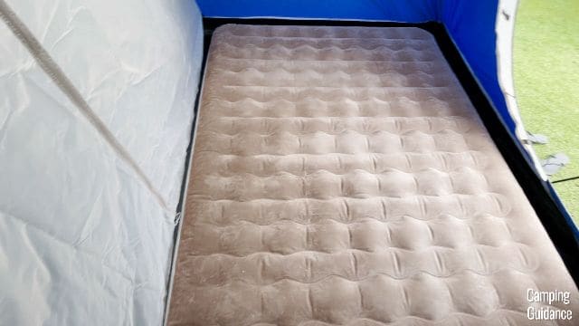 Each room of the Coleman Elite Sundome Tent, with the divider up, can fit 1 queen bed. The queen bed in this picture has dimensions of 80 by 59 inches.