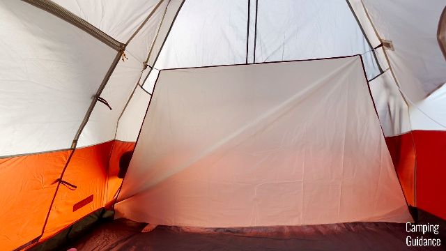 This is a picture of me setting up one of the dividers of the Coleman Red Canyon 8-Person Tent.
