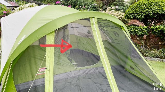 The red arrow in the picture is pointing to the open door of the Coleman Evanston 6-Person Tent.