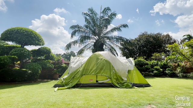 This is a picture of the rainfly being draped over the Coleman Montana 8-Person Tent.