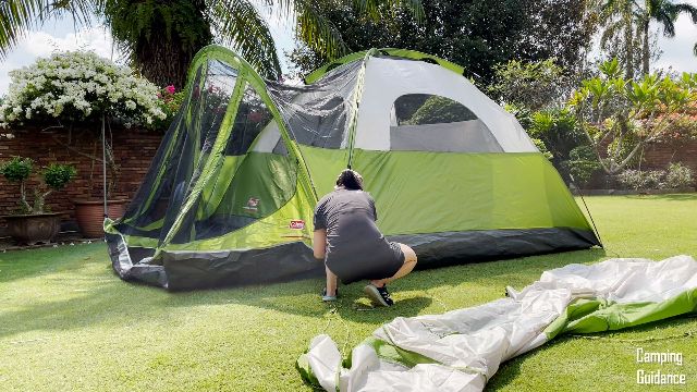 This is a picture of me securing the gray pole for the screen room of the Coleman Evanston 6-Person Tent.