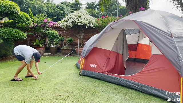This is a picture of my brother guying out one of the guylines of the Coleman Red Canyon 8-Person Tent.