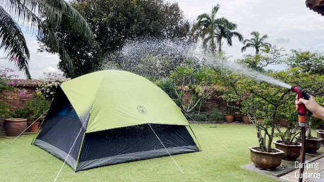 This is a picture of me using a water hose to hose down my Coleman Sundome Dark Room Tent.