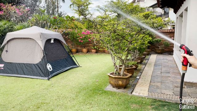 This is a picture of me using a water hose to hose down the Coleman Instant Tent 4.