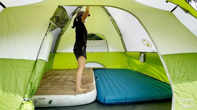 The author standing on a 9-inch thick mattress inside the Coleman Sundome 6-Person Tent.