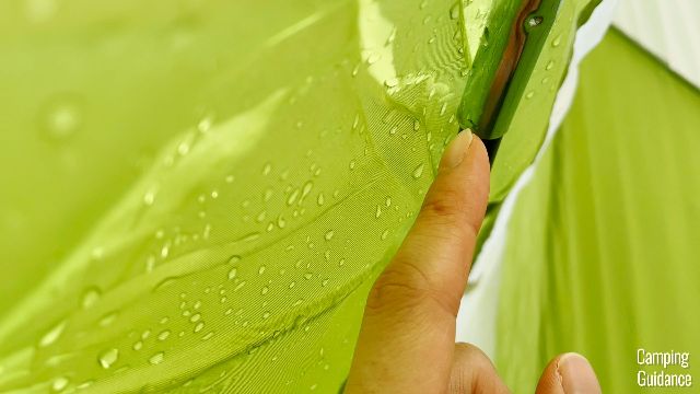 Notice the small droplets of water on the pole of the Coleman Montana 8-Person Tent, which is under the rainfly.
