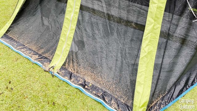 Dirt and leaves trapped in the mesh of the screen room of the Carlsbad Tent.
