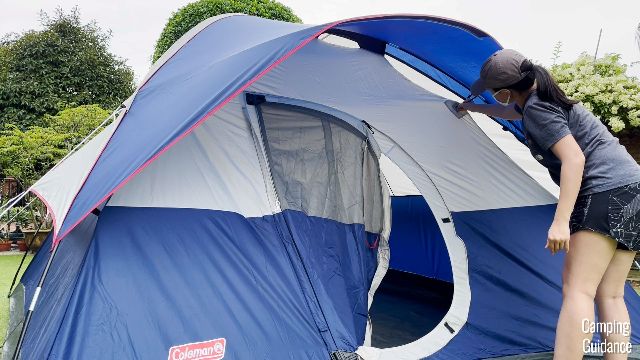 This is a picture of me securing the rainfly pole at the front of the Coleman Elite Sundome Tent.