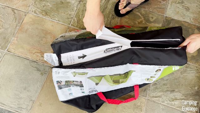 This is a picture of me ripping the strip off the bottom of the Coleman Montana Tent’s carry bag to expand it.