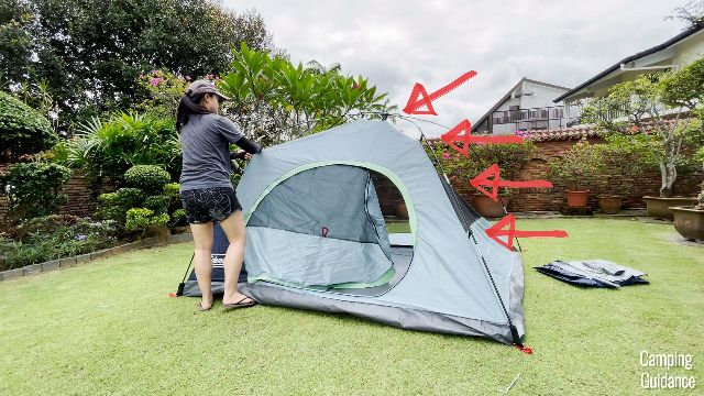 This is a picture of me clipping all the pole clips to the fiberglass poles at the front of the Coleman Skydome Tent.