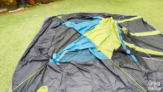 The first 2 poles of the Coleman Carlsbad Tent have been inserted through the respective pole sleeves.