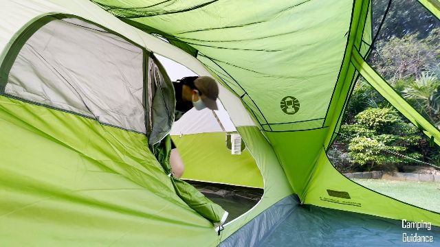 This is a picture of me exiting the Coleman Evanston 6-Person Tent through the door.