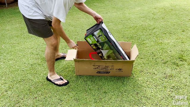 This is a picture of my brother taking the Coleman Montana 8-Person Tent out of the cardboard box.