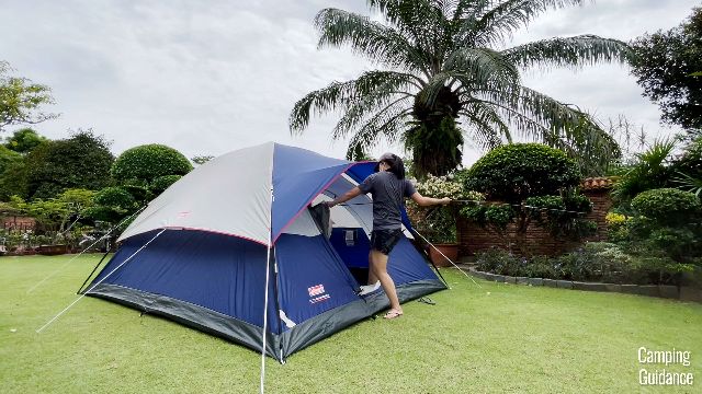 This is a picture of me installing the hinged door of the Coleman Elite Sundome Tent.