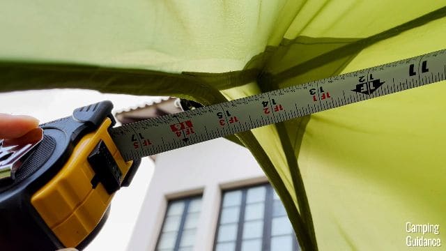 Me measuring how far each awning extends out over the tent.