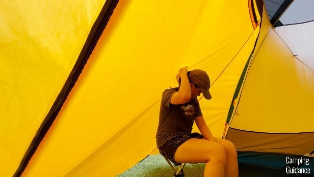 Me sitting on the REI Trail Stool in the back vestibule of the REI Base Camp 6.