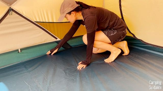 Me touching one of the flooring seams in the REI Base Camp 6.