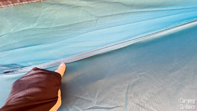 A close-up of one of the un-taped flooring seams of the REI Base Camp 6.