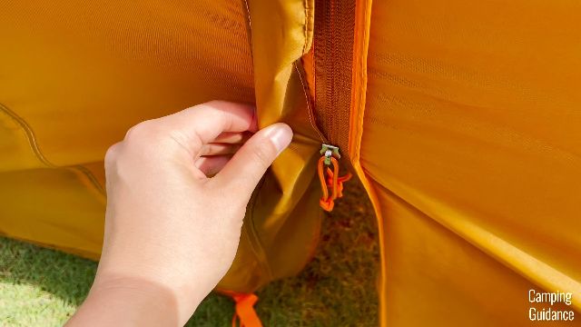 The rain flap trapping the zipper of the vestibule door.
