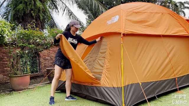 Me holding the door fabric of the Wawona 6 with one hand, and unzipping the window fabric with the other hand.