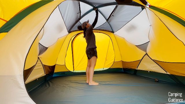 The author standing under the peak height of the REI Base Camp 6.