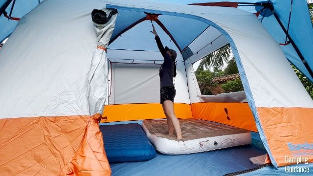 The author standing on a 9-inch mattress in the Eureka Copper Canyon LX 6.