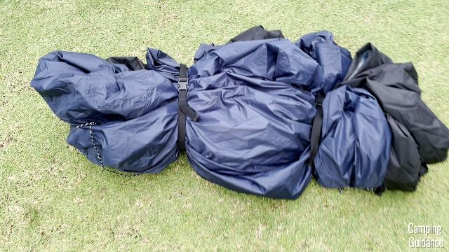 The tent body (black) and the rainfly (blue) of the Caddis Rapid 6 held together by the 2 provided compression straps.