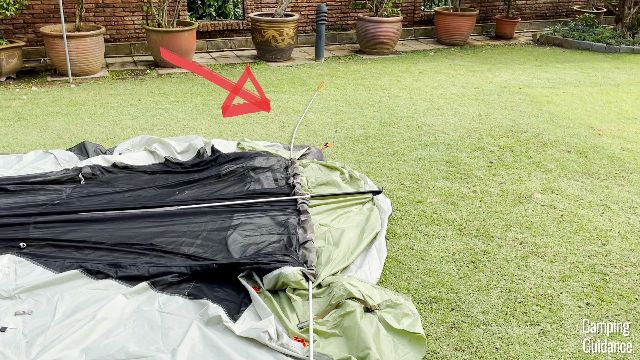 The red arrow is pointing to the bent section of the orange pole.