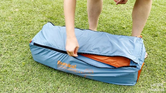 The author packing away the Eureka Copper Canyon LX 6 back into the carry bag
