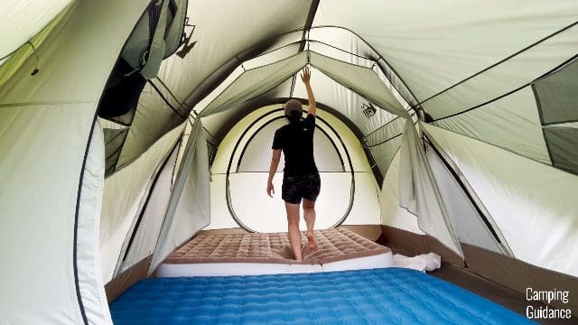 Me standing on a 9-inch mattress in the REI Wonderland 6.