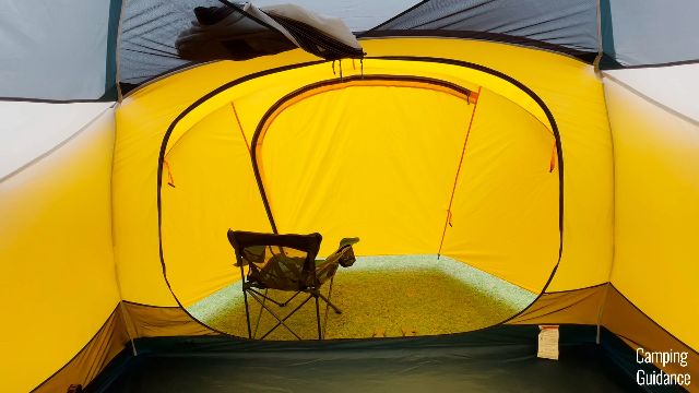 A camping chair in the front vestibule of the REI Base Camp 6