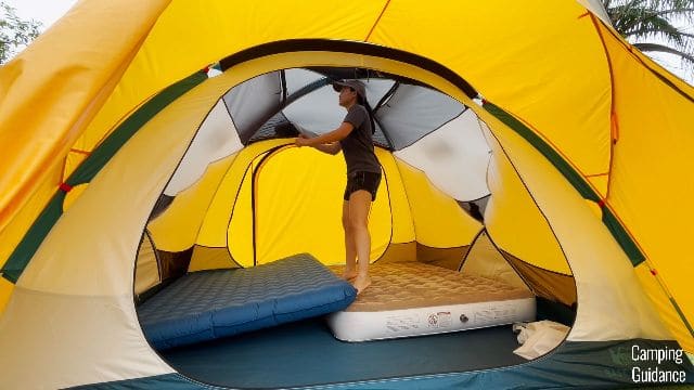 Me standing on a 9-inch mattress inside the REI Base Camp 6, and bouncing on it.