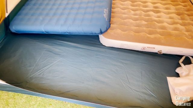 A close-up of what 2 queen beds look like inside the REI Base Camp 6. Notice the decent amount of space for gear.