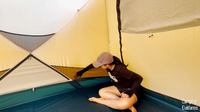 Me checking the fabric of the REI Base Camp 6.