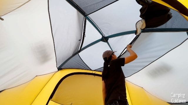 The author shutting one of the roof vents in the REI Base Camp 6.