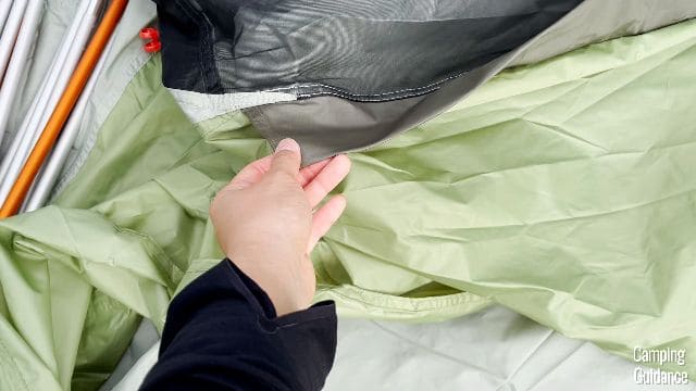Me touching one of the pole sleeves of the REI Wonderland 6.
