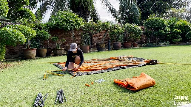 This is a picture of me sleeving the orange poles through the orange pole sleeves.