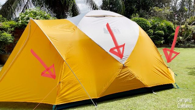The red arrows are pointing to the guy-out points on the REI Base Camp 6.