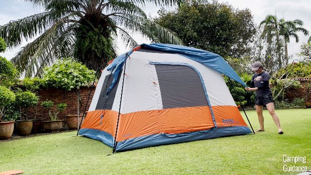 This is a picture of me securing the rainfly of the Eureka LX 6.