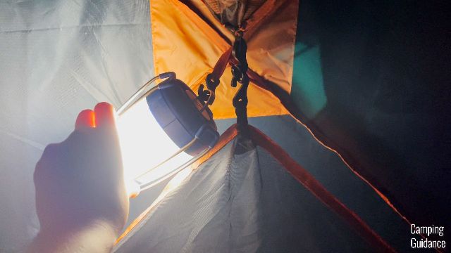 Hanging up a lantern in the Eureka LX 6. Notice that the gear lofts are still in place.