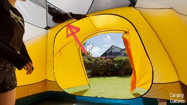 The doors to the REI Base Camp 6 have overhead door pockets to keep the doors open (the red arrow is pointing to one of the pockets).