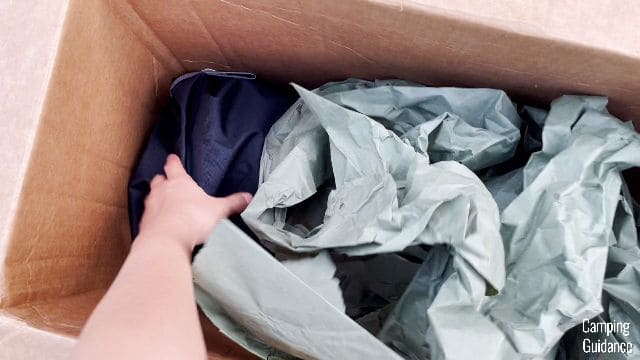 A close-up shot of me taking the REI Wonderland 6 out of the cardboard packaging.