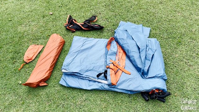 From left to right: Stakes (orange carry bag), poles (another orange carry bag), gear loft (black), tent body (blue), rainfly (blue).