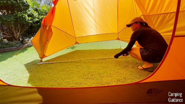 This is a picture of me measuring the longest length of the Wawona 6's vestibule.