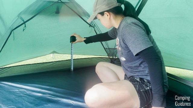 The author measuring the height of the tub floor in the Hyke and Byke Zion 2 Tent.