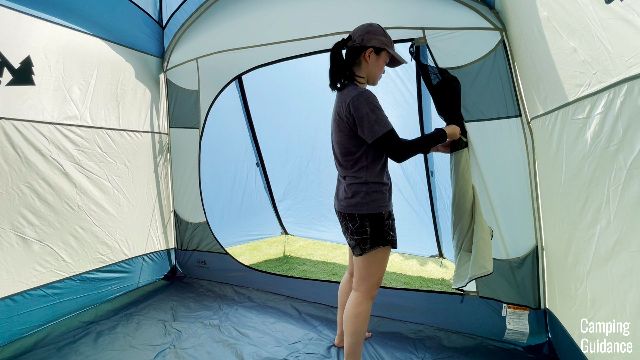 The author using the door toggle of the REI Skyward 4 to keep the door open