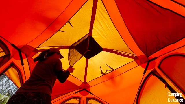 the author attaching the gear loft of the Gazelle T4 Hub Tent