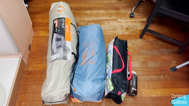 What the Ozark Trail Dark Rest Instant Cabin 6 looks like beside a Eureka Copper Canyon LX 6 and a Coleman Sundome 2